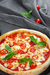Fresh margarita pizza with tomatoes, basil, mozzarella cheese
