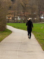 Blonde woman running in a park