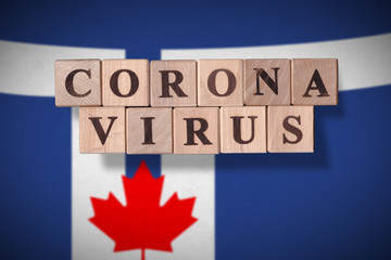 Flag of the city of Toronto with wooden cubes spelling coronavirus on it. 2019 - 2020 Novel Coronavirus (2019-nCoV) concept, for an outbreak occurs in Toronto, Canada.