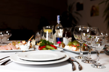 Restaurant tables set for celebration.  Many food on the festive table