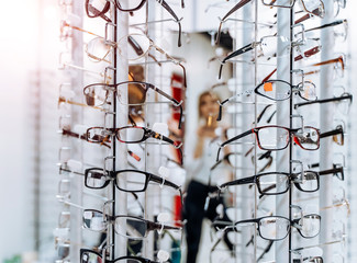 Sales rack of glasses. Display of glasses for sale. Closeup. Stand with glasses in the store of optics.