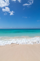 Fototapeta na wymiar Looking out over a turquoise ocean with a blue sky overhead, on the Caribbean island of Barbados