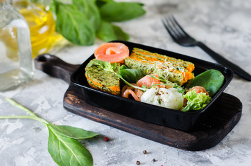 Healthy food and diet concept, restaurant dish delivery. Take away of fitness meal. Weight loss nutrition in boxes. Healthy lunch - fish, poached egg and carrot cake.