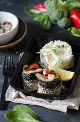 Healthy food and diet concept, restaurant dish delivery. Take away of fitness meal. Weight loss nutrition in boxes. Healthy lunch - side dish of creamy risotto with microgreen and baked mackerel