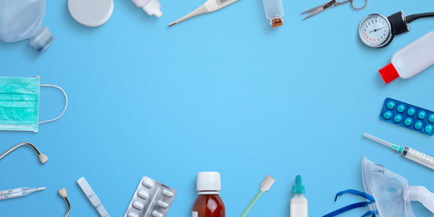Medical equipment and medicines on the table. Top view, flat lay scene with copy space in the middle