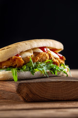 panini sandwich with crispy chicken and rucola salad