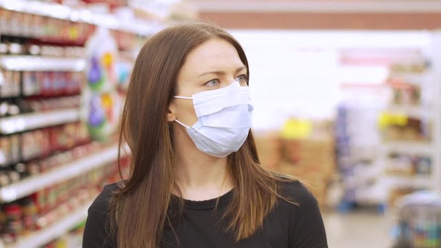 Woman Shopping In Grocery Store For Food While Wearing PPE And Preventing Spread Of Virus Germs By Wearing Face Mask.