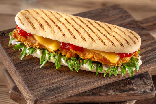 panini sandwich with crispy chicken and rucola salad
