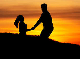 Fototapeta na wymiar Lovers couple in sunset time in nature ( shilouette )
