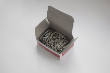 Paper clips in box isolated on white background
