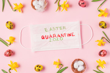 Coronavirus covid 19 quarantine concept. Frame made of Easter eggs and spring narcissus flowers with face medical mask