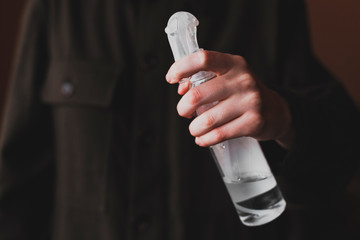 Close-up of hands applying alcohol spray against coronavirus, close up. Antiseptic spray to prevent spread of germs, bacteria, coronavirus and virus. Antiseptic and sanitizer.