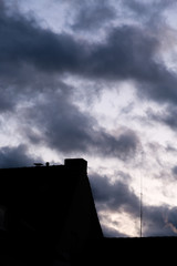 Silhouette of building and dramatic cloudy sky