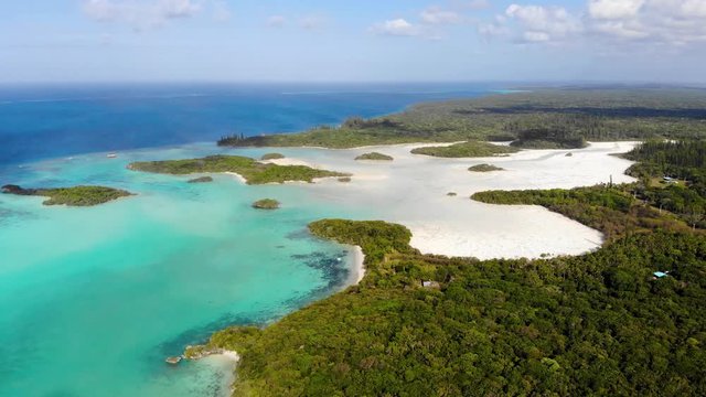 Aerial drone footage of Gadji and Crabes Bay located at the north end of the Isle of Pines in New Caledonia. The area is full of small beaches and numerous islets.