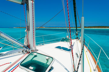 Sailboat anchored in Bahamas with blue water and blue sky
