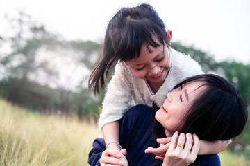 Mother and daughter hugging and lying outdoors with smillig,Concept of I love you mom