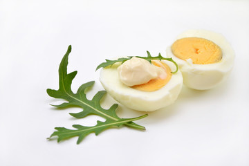 boiled egg and arugula on a white background
