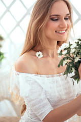 the girl enjoys her morning coffee and enjoys a bouquet of flowers