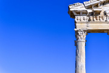 Fototapeta na wymiar antique columns in the old city of Side against the blue sky in Turkey, background for a copy of the space
