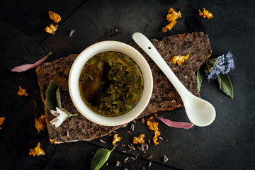 Herbal tea in a tea bowl on a piece of wood