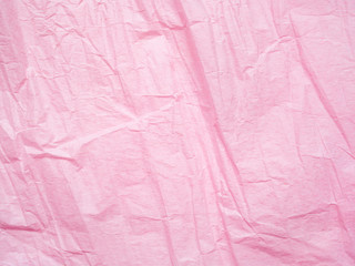 Pink crumpled paper texture background. Macro shot of wrapping paper. Creased sheet backdrop. Textured effect of page. Abstract pattern, pink backdrop surface. Wrinkled texture of sheet