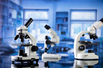 Modern scientific laboratory interior. Reaserch station with microscopes on the glass table.