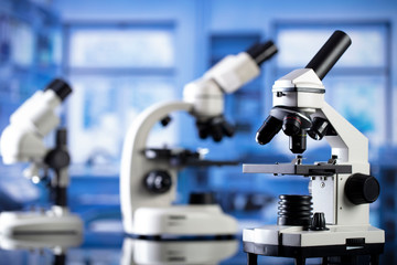 Modern scientific laboratory interior. Reaserch station with microscopes on the glass table.
