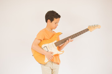 Obraz premium Boy is playing with his guitar