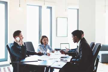 Young businesspeople discussing project plan in office