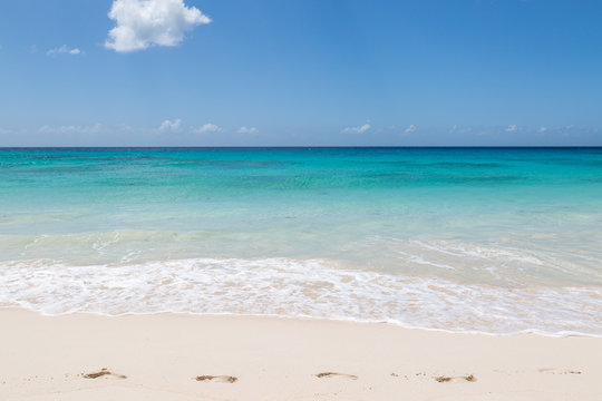 Footprints on an idyllic sandy beach, on the Caribbean island of Barbados