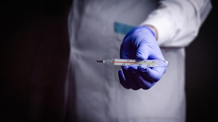 doctor thermometer in hand medical gloves blue fever disease treatment