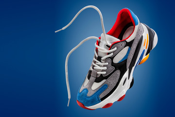sports shoes, sports sneakers on a blue background with space for the inscription, copy-space