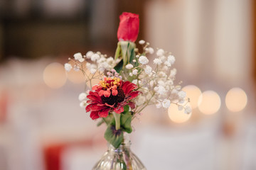 Table decoration with red and white flowers at a wedding