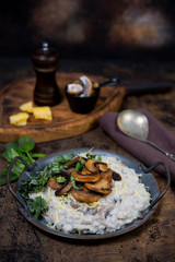 Fototapeta na wymiar Italian dish risotto with mushrooms, Parmesan and herbs.