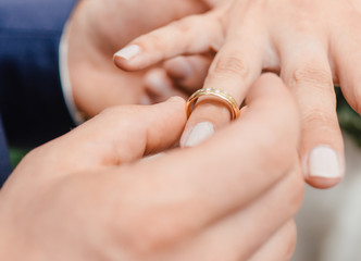 Wedding Ring Gold is put on finger romantic sign of love and engagement