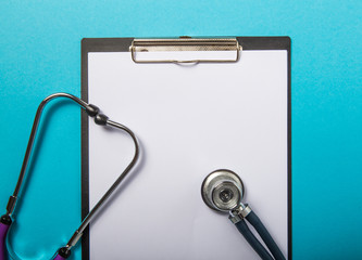 Medical clipboard with stethoscope  on blue