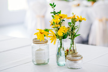 Yellow Flowers as decoration on dinner table thanks giving harvest celebration