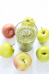 Mixed green smoothie with apples on a white background