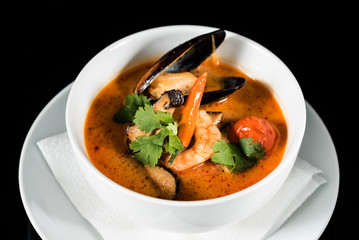 seafood soup on the black background