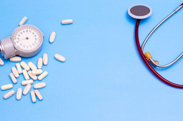 Stethoscope, pads and tonometer on a blue background. Place for your text. Medical background.