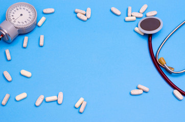 Stethoscope, pads and tonometer on a blue background. Place for your text. Medical background.