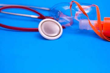 Stethoscope and mask for ventilation of the lungs on a gray background. Device for listening to the...