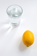 glass of water and lemon isolated on white