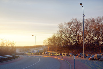 A view of the empty snow-covered seaside promenade at sunset. No people because of coronavirus...