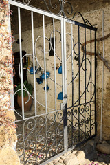 Bussana Vecchia (IM), Italy - December 12, 2017: An iron doorway in a house in Bussana Vecchia, Imperia, Liguria, Italy