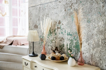 scandinavian decoration on concrete background.Dried flowers and vegetation in a modern interior. Interior decor in eco-style with greenery.home interior. Scandinavian cozy light interior of living