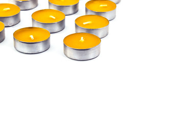 On a white background, a small number of scented candles. When the candles are lit , the aroma of mango is present