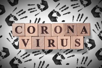 Hand stamp background with wooden cubes spelling coronavirus on it. 2019 - 2020 Novel Coronavirus (2019-nCoV) concept art, for an outbreak occurs of covid-19 and its consequences.