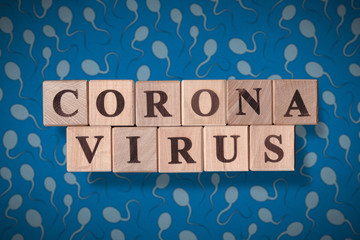 Sperm background with wooden cubes spelling coronavirus on it. 2019 - 2020 Novel Coronavirus (2019-nCoV) concept art, for an outbreak occurs of covid-19 and its consequences.
