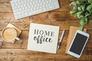 Home office and working from home concept. Table workplace with keyboard computer, notepad and...